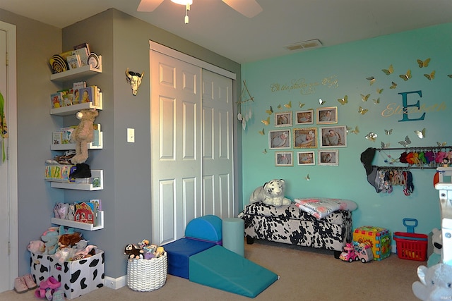 carpeted bedroom with ceiling fan and a closet