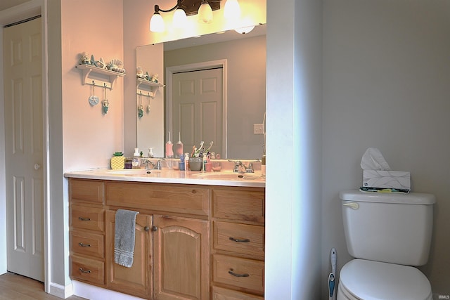 bathroom featuring hardwood / wood-style floors, vanity, and toilet