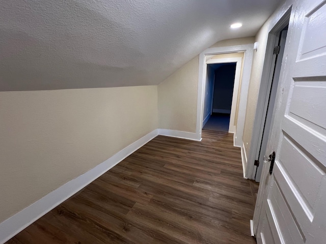 bonus room featuring dark hardwood / wood-style floors and lofted ceiling