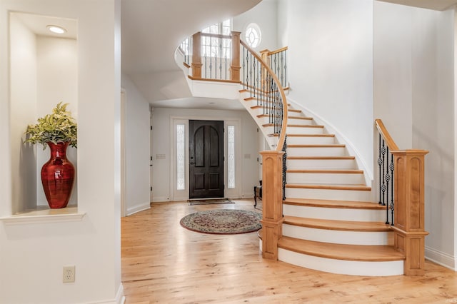 foyer featuring a high ceiling and light wood-type flooring