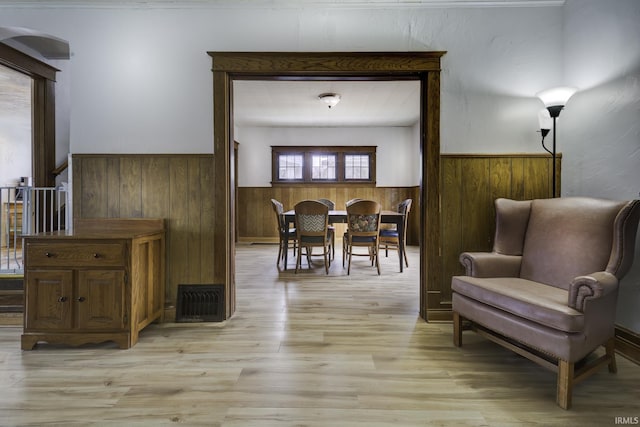 interior space with wood walls and light wood-type flooring