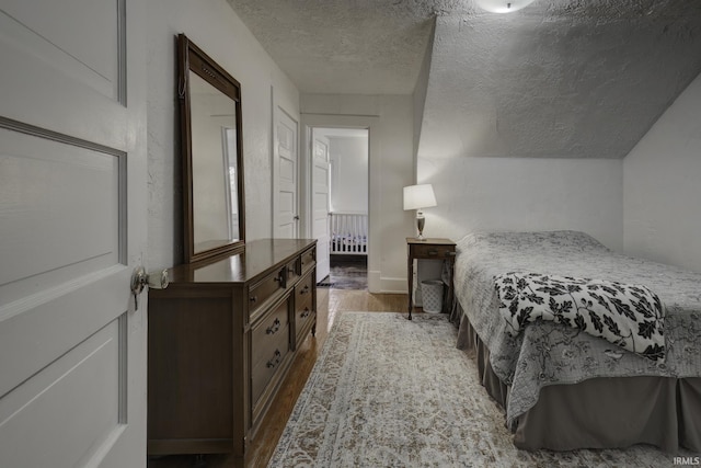 bedroom featuring hardwood / wood-style floors and a textured ceiling