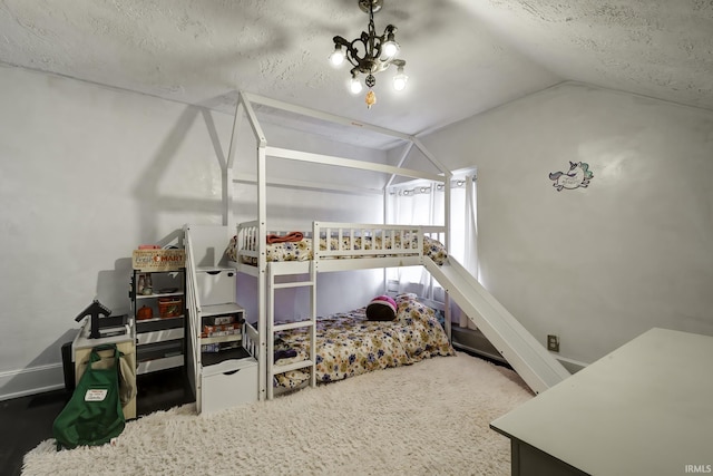 bedroom featuring carpet, a textured ceiling, and lofted ceiling