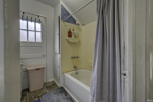 bathroom with shower / tub combo and lofted ceiling