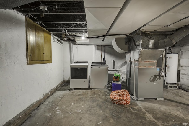 basement featuring heating unit, washer and dryer, and gas water heater