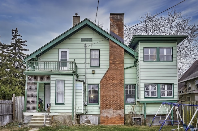 rear view of house featuring a balcony