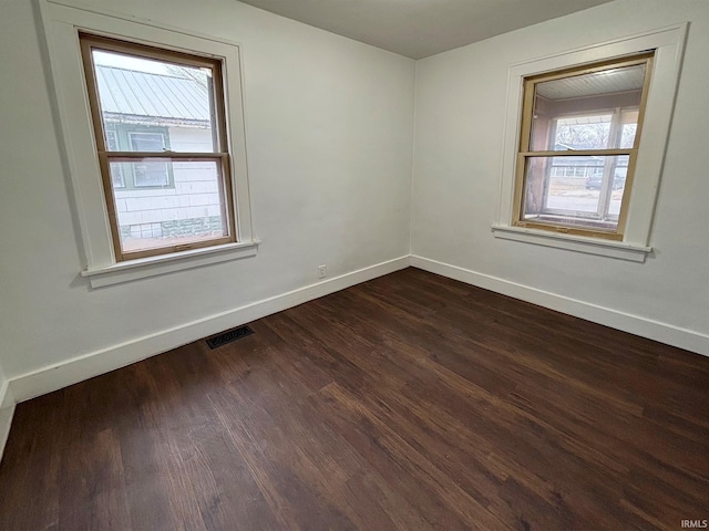 spare room featuring dark wood-type flooring