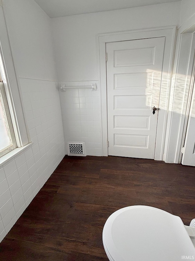 bathroom featuring tile walls and hardwood / wood-style floors