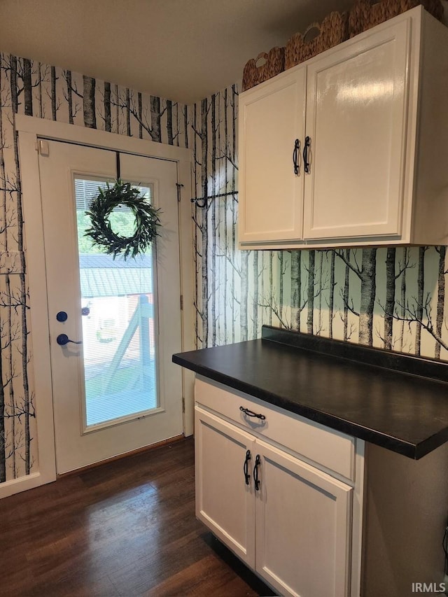 kitchen with white cabinets and dark wood-type flooring