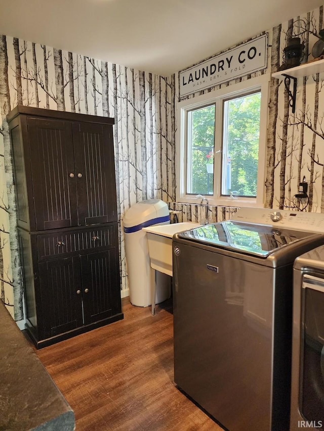 washroom featuring hardwood / wood-style floors and washer and dryer