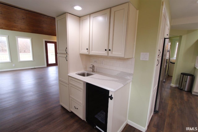 kitchen with white cabinets, dark wood-type flooring, and sink