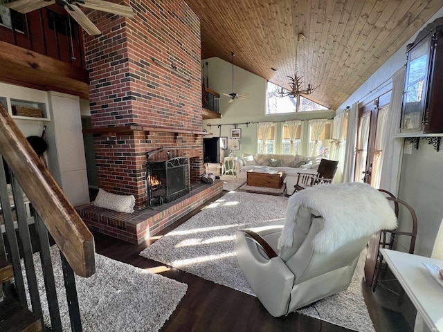 living room with ceiling fan, wooden ceiling, a brick fireplace, high vaulted ceiling, and dark hardwood / wood-style floors