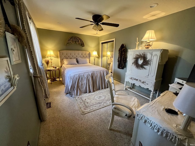 carpeted bedroom featuring ceiling fan and a closet