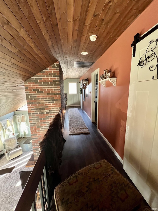 corridor featuring brick wall, hardwood / wood-style flooring, vaulted ceiling, and wood ceiling