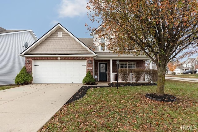 view of front of house featuring covered porch, a garage, and a front lawn