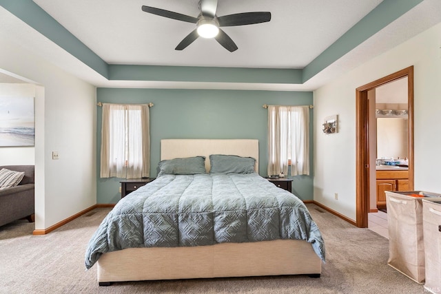 carpeted bedroom featuring ensuite bath and ceiling fan