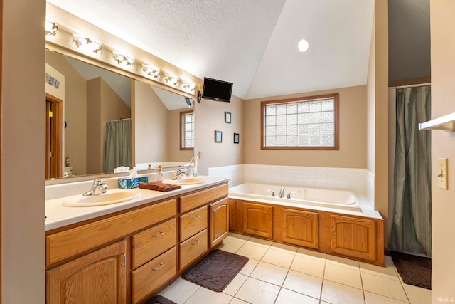 bathroom featuring vanity, a bath, tile patterned floors, vaulted ceiling, and a textured ceiling