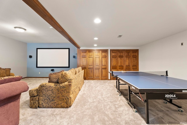 cinema room featuring light colored carpet