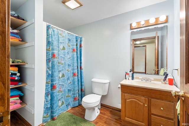 bathroom featuring a shower with shower curtain, wood-type flooring, vanity, and toilet