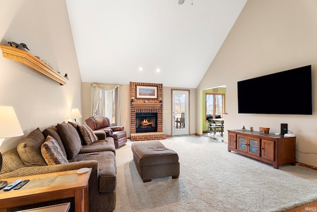 carpeted living room with high vaulted ceiling and a brick fireplace