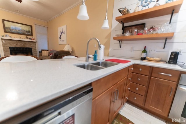 kitchen featuring sink, pendant lighting, stainless steel dishwasher, and ornamental molding