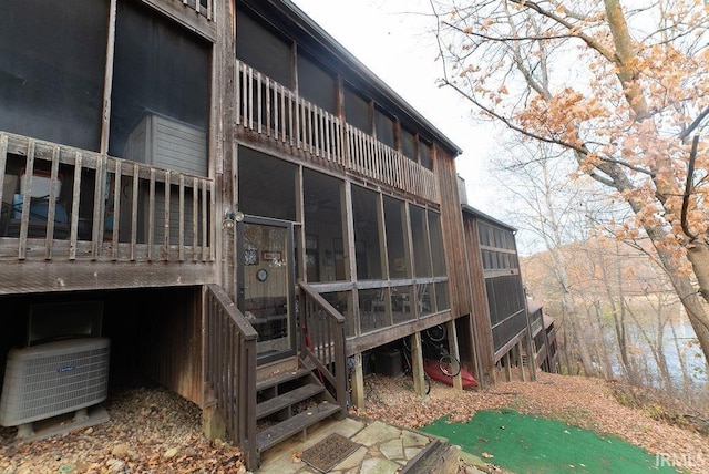 rear view of property with central AC unit