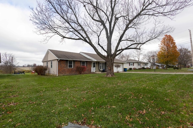 ranch-style house featuring a garage and a front yard