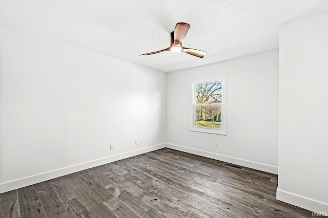 unfurnished room with a textured ceiling, ceiling fan, and dark hardwood / wood-style floors