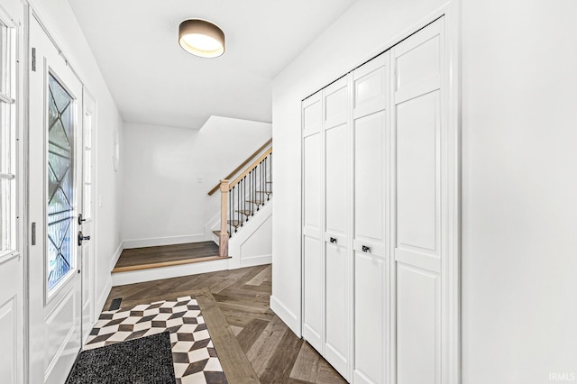 entrance foyer with dark parquet flooring