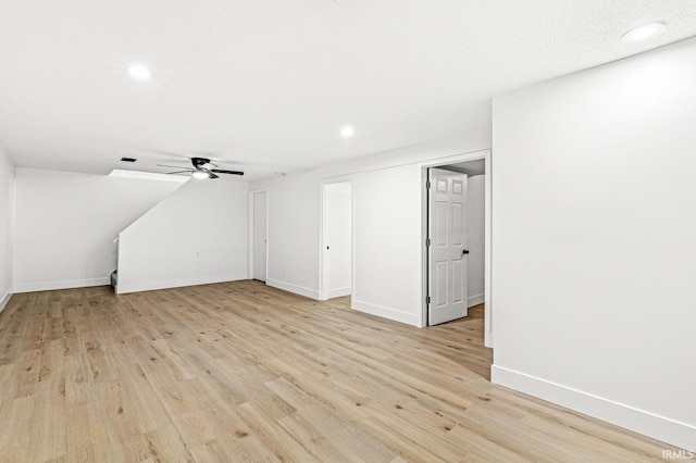 bonus room with ceiling fan and light hardwood / wood-style floors