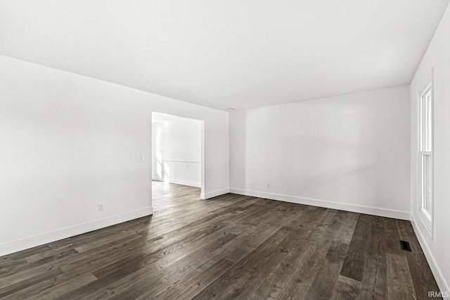 empty room featuring dark wood-type flooring