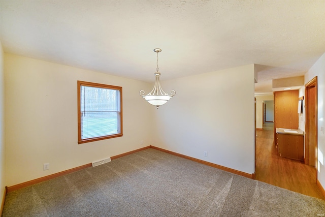 unfurnished room with hardwood / wood-style floors