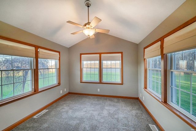 carpeted empty room with plenty of natural light, ceiling fan, and lofted ceiling