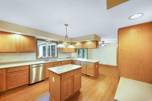 kitchen with pendant lighting, a kitchen island, stainless steel dishwasher, and light hardwood / wood-style flooring