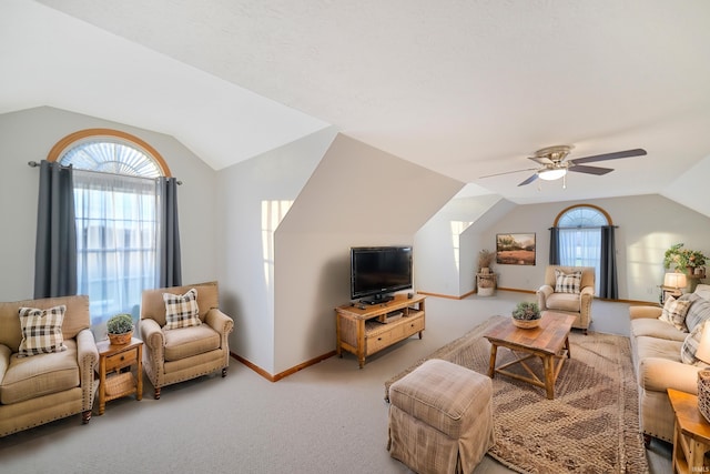 carpeted living room featuring vaulted ceiling and ceiling fan