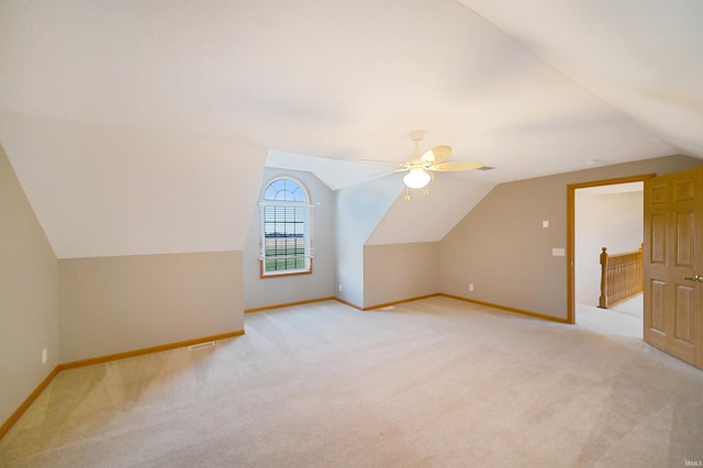 bonus room featuring lofted ceiling and light carpet