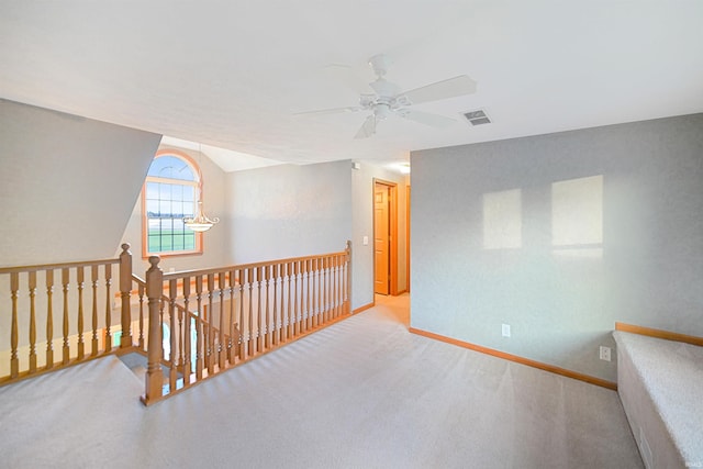 hallway with carpet flooring and lofted ceiling