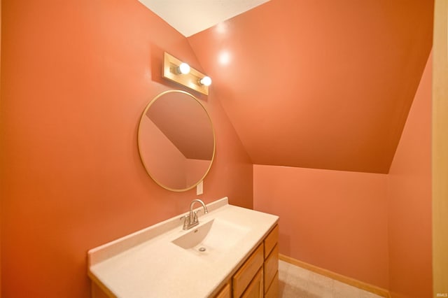 bathroom with vanity and lofted ceiling