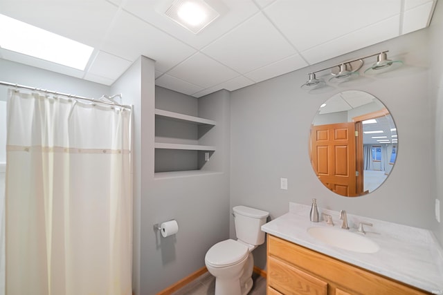 bathroom featuring vanity, a paneled ceiling, toilet, and a shower with shower curtain