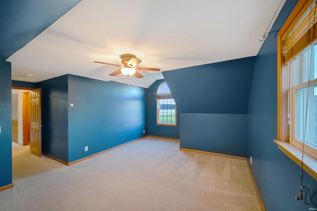 bonus room with light carpet, ceiling fan, and vaulted ceiling