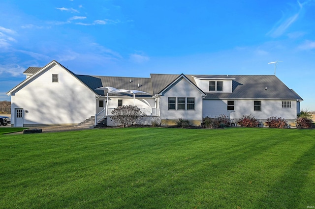 back of house with a lawn