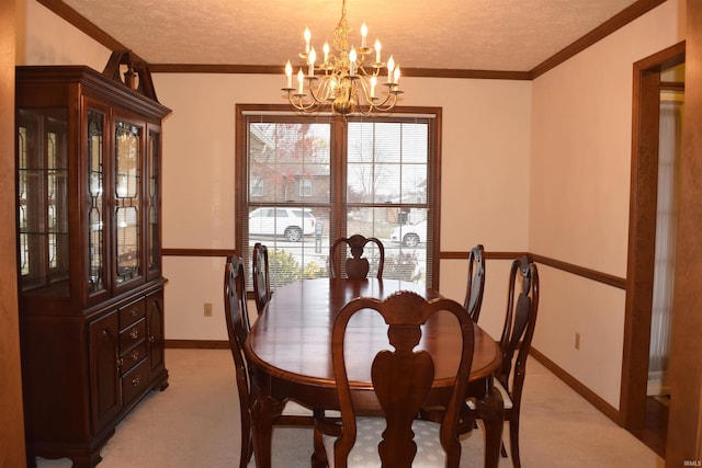 dining area featuring a chandelier, a textured ceiling, light colored carpet, and crown molding