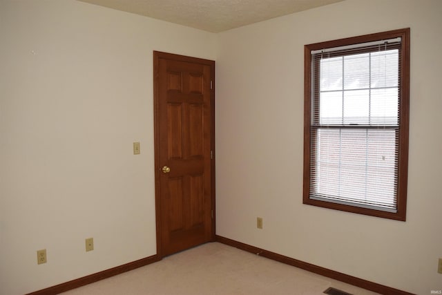 spare room with a textured ceiling