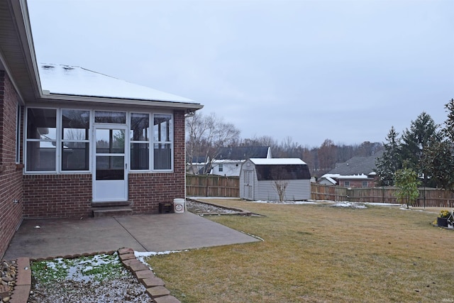 view of yard with a storage unit and a patio area