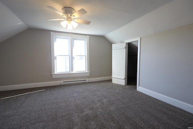 bonus room featuring dark colored carpet, vaulted ceiling, baseboard heating, and ceiling fan