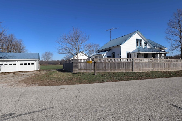 view of property exterior with an outbuilding and a garage