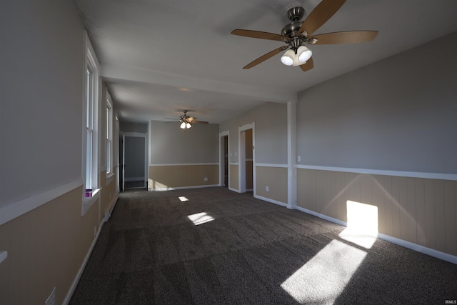 carpeted empty room featuring ceiling fan