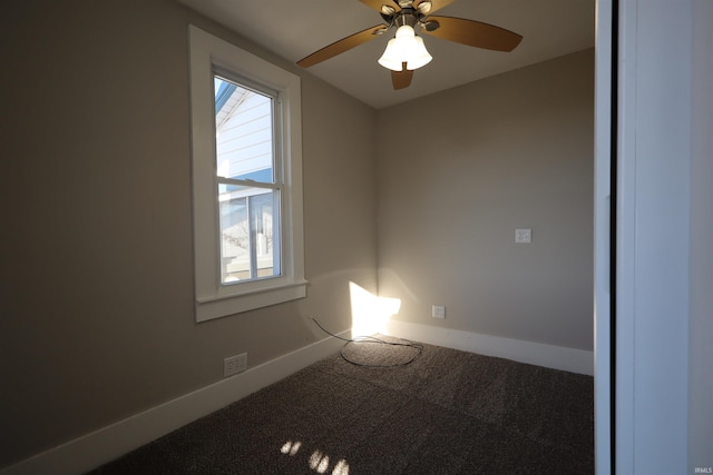 spare room with ceiling fan and carpet