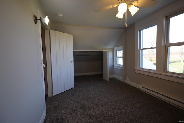 unfurnished bedroom with ceiling fan, dark carpet, lofted ceiling, and baseboard heating