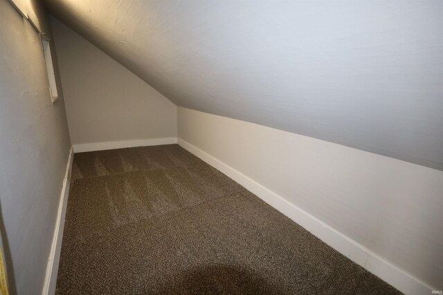 bonus room featuring carpet flooring and vaulted ceiling
